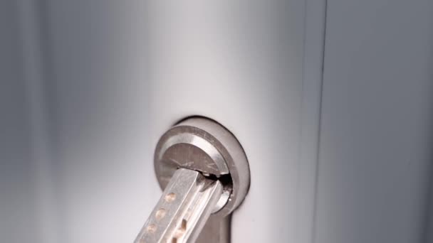 Inserting Key Keyhole White Plastic Door Close Turning Key Lock — стоковое видео