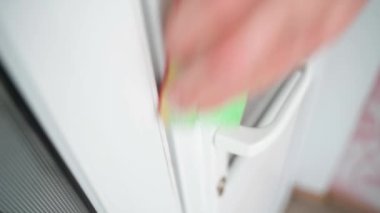 Washing white plastic doors with a sponge and detergent, close-up. High quality 4k footage