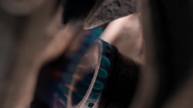 Ancient kitchen stove with a blue flame from a burning gas in a gas burner close-up, blurred background. Smooth camera rotation. High quality FullHD footage
