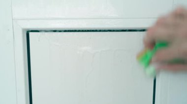 Washing white plastic doors with a sponge and detergent, close-up. High quality 4k footage