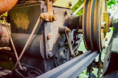 Pulley for transmitting torque from the engine to the distributor gearbox on a walk-behind tractor. V-belt in grooves. Drive belt old worn out on a yellow pulley, blurred background