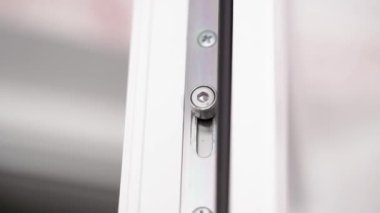 The mechanism of change of position and blocking in plastic doors of white color. Rubber compressor. High quality FullHD footage