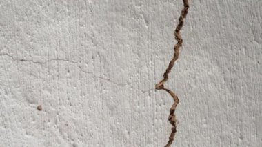 Camera movement along a crack in the ceiling. Clay ceiling of an old house with a large gap. A long break in the wall due to natural disasters. Condition of housing after explosions and earthquakes