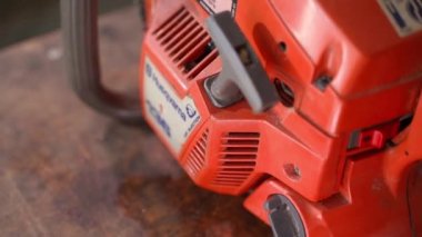 Kiev, Ukraine - August 23,2022: Old chainsaw Husqvarna 136 air injection close up. Chainsaw of the old generation.Smooth camera movement, top view. High quality FullHD footage