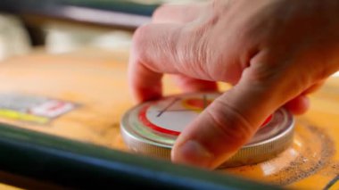 Close-up of unscrewing the gas tank cap of a gas generator. The hand unscrews and tightens the fuel filler cap. Filling a canister at a petrol station. High quality 4k footage