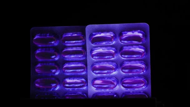 Two Blisters Fish Oil Capsules Close Iridescent Multi Colored Light — Stock video