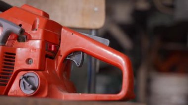 Kiev, Ukraine - August 23,2022: Old chainsaw Husqvarna 136 air injection close up. Chainsaw of the old generation.Smooth camera movement, top view. High quality FullHD footage