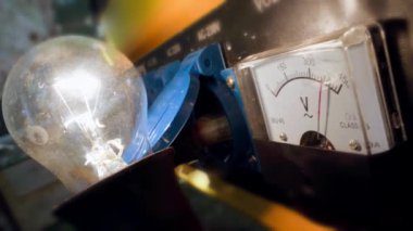 A voltmeter on the body of a working gas generator shows the output voltage close-up.Generation of electricity by a gasoline engine. The arrow of the measuring scale fluctuates. Unstable engine speed