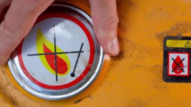 Close-up of unscrewing the gas tank cap of a gas generator. The hand unscrews and tightens the fuel filler cap. Filling a canister at a petrol station. High quality 4k footage