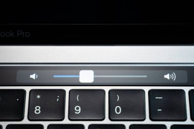 Kiev, Ukraine - August 9, 2022: Volume slider on touch bar apple macbook pro closeup