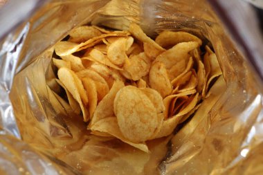 Potato chips in a package inside. Snacks in a package close-up.