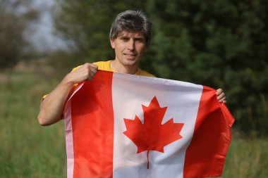 Canada flag In the hands of a man