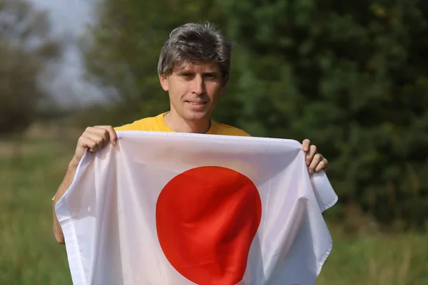 Σημαία Της Ιαπωνίας Στα Χέρια Ενός Άνδρα Καυκάσιας Φυλής — Φωτογραφία Αρχείου