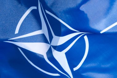 LVIV, UKRAINE - September 30, 2021: NATO silk flag close-up