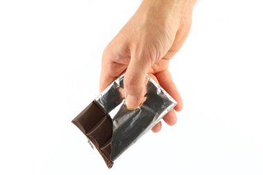 Hand holds a bar of chocolate isolate close-up