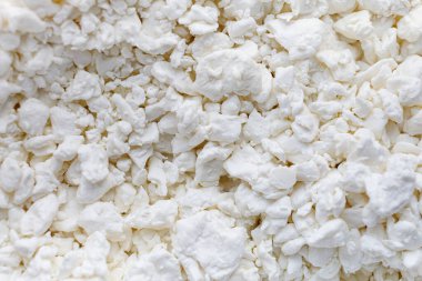 White cottage cheese. Grainy cheese close-up