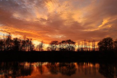 Sunset over the lake. Red sky. Beautiful landscape