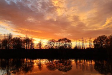 Sunset over the lake. Red sky. Beautiful landscape