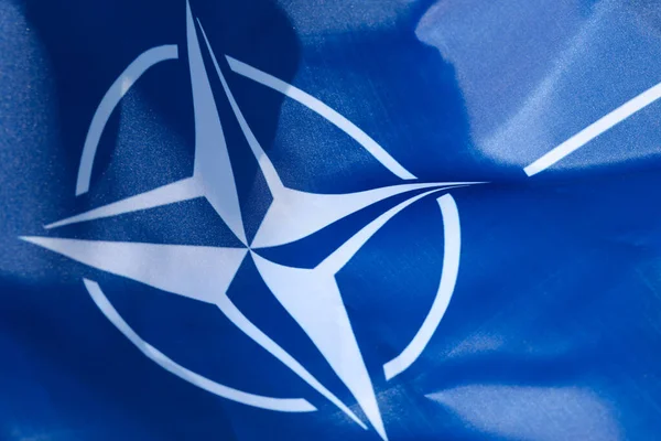 LVIV, UKRAINE - September 30, 2021: NATO silk flag close-up