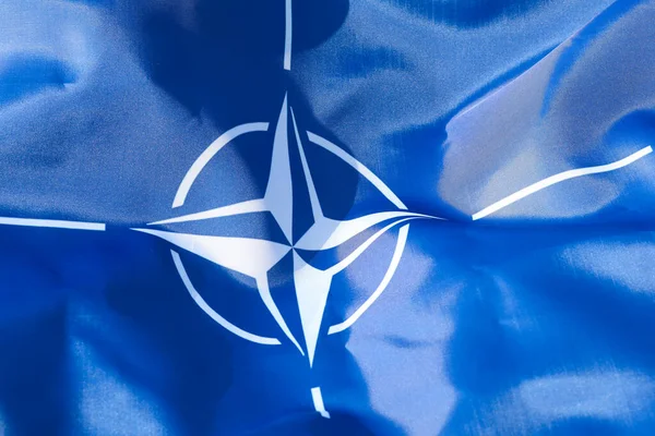 LVIV, UKRAINE - September 30, 2021: NATO silk flag close-up
