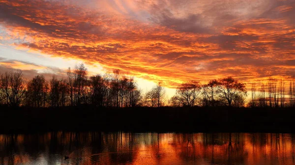 Sunset over the lake. Red sky. Beautiful landscape