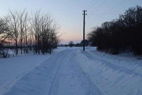 Uninhabited road in winter in the village or town