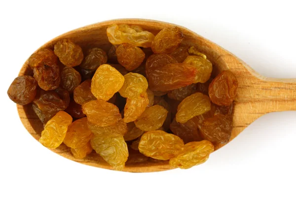Yellow raisins in a wooden spoon