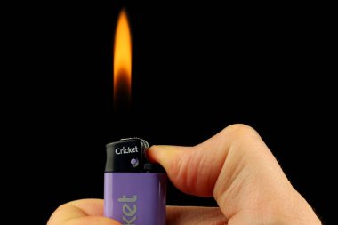 LVIV, UKRAINE - January 06, 2022: Cricket Lighter in hand
