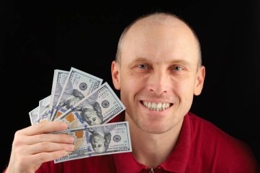 White man holding money dollars and laughing