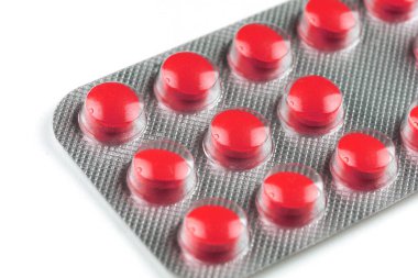 Red pills in a transparent blister