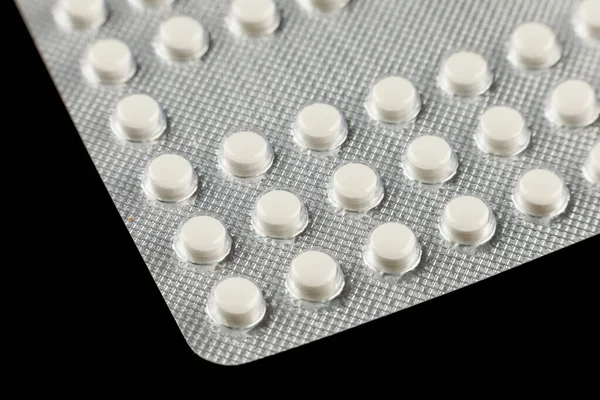 White pills in a transparent blister