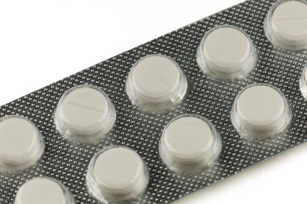 White pills in a transparent blister