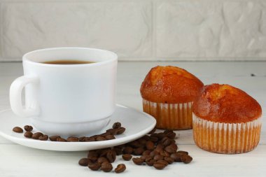 muffin and coffee on white. Delicious breakfast.