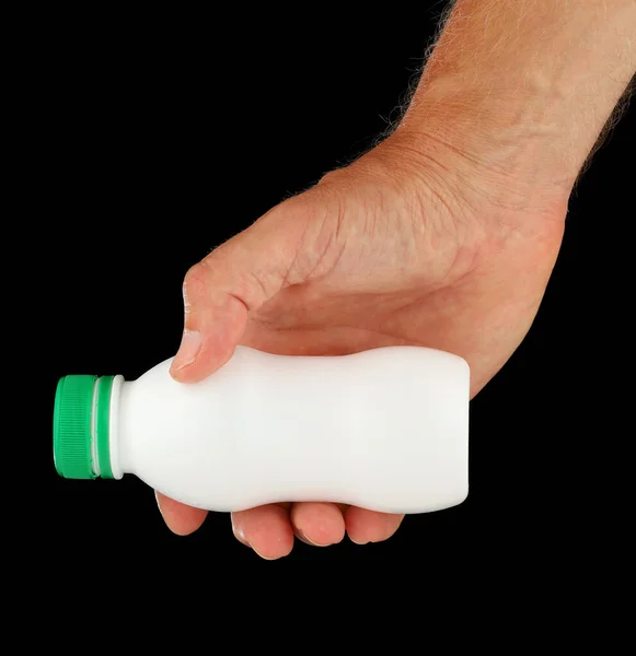 White plastic bottle in hand