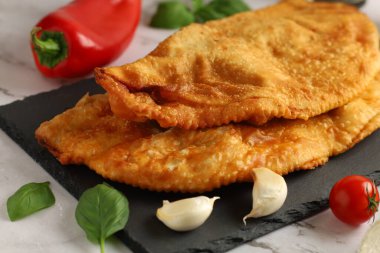 Chebureks with meat. East meat pastry cheburek. Fried chebureks, close-up