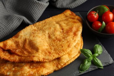 Chebureks with meat. East meat pastry cheburek. Fried chebureks, close-up