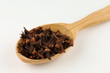 Clove spice in a wooden spoon