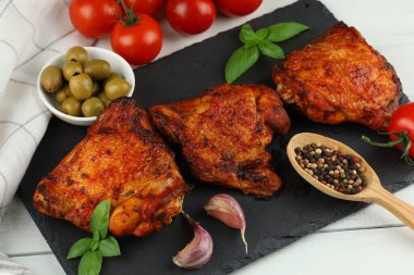 Chicken thighs baked with vegetables and spices. Grilled chicken meat