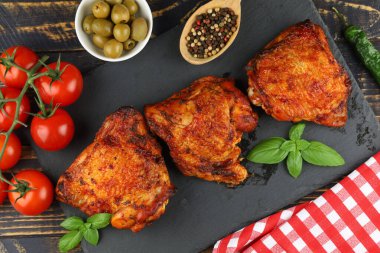 Chicken thighs baked with vegetables and spices. Grilled chicken meat