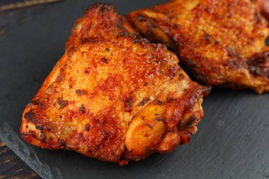 chicken thighs Baked. Roasted chicken thighs. Appetizing cooked chicken.