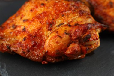chicken thighs Baked. Roasted chicken thighs. Pieces of fried meat.