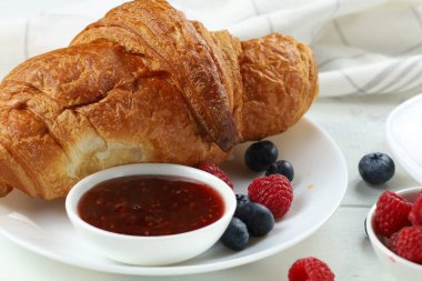 Reçelli ve dutlu kruvasan. Geleneksel kahvaltı. Lezzetli kahvaltı - taze kruvasan, reçel ve ahududu