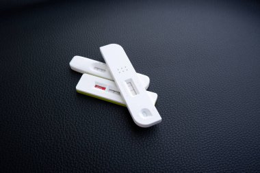 Multiple covid-19 Test cassette with positive result on artificial leather background,Coronavirus infectious protective concept