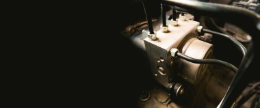 ABS unit module control box with pipes of a car brake system with horizontal copy space on black background