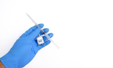 Monkeypox and smallpox virus vaccine bottle (MPXV) and syringe in a medical personnel hand with horizontal copy space on white background