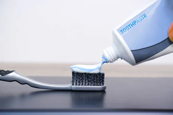 Hand Squeezed White Toothpaste Gray Toothbrush Left Copy Space — Stock Photo, Image