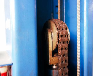 Metal chain of the automatic car lift machine in the auto repair garage.