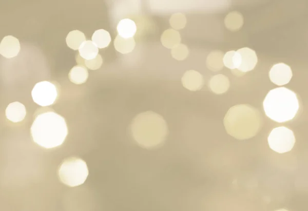 Bright lights on beige clear background. bokeh style. Christmas and Happy New Year concept. Minimal concept.