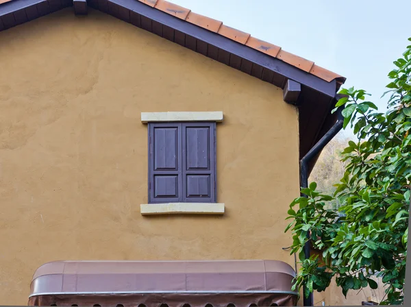 Janela de madeira em uma parede de casa — Fotografia de Stock