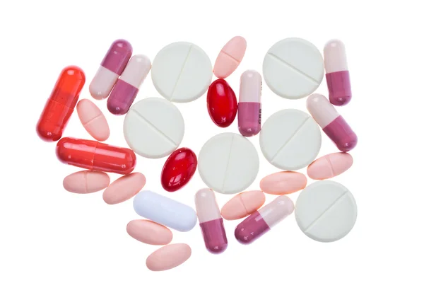 Барвисті таблетки медицини на білому тлі — стокове фото